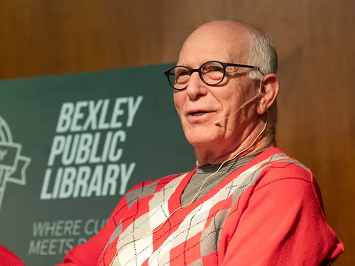 Rex Kern in front of sign for bexley public library