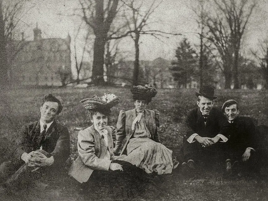 old black and white photo of men and women sitting on a lawn