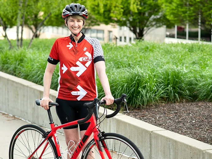 Ohio State President,Kristina M. Johnson, standing next to her bicycle