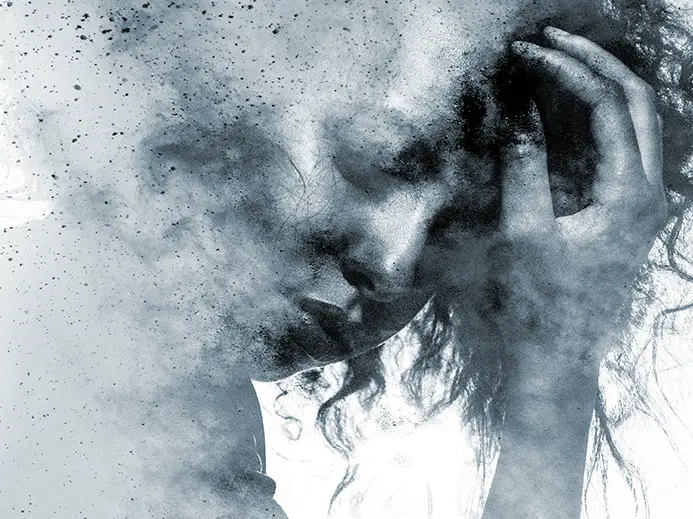 woman in a dusty cloud holding her head with one hand