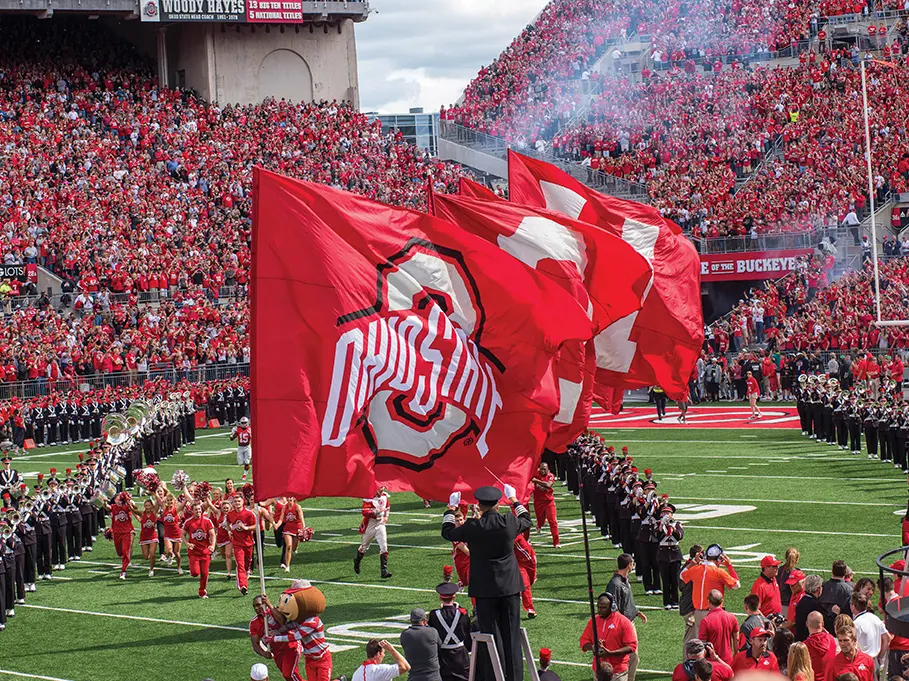 Cheerleaders fly giant flags at Ohio Stadium