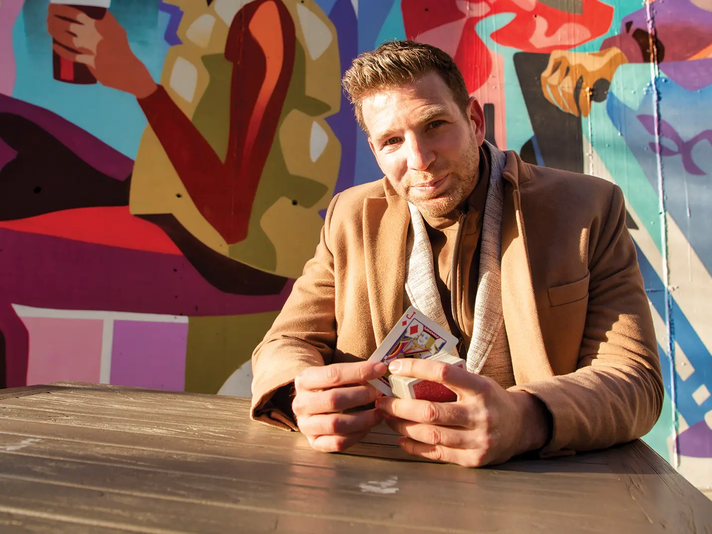 portrait of Joshua Jay in front of a colorful wall