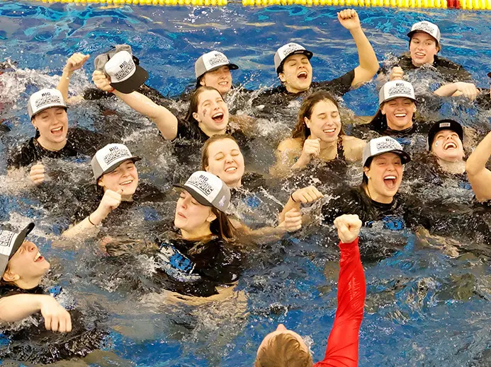 OSU women's swimming team celebrating in a pool