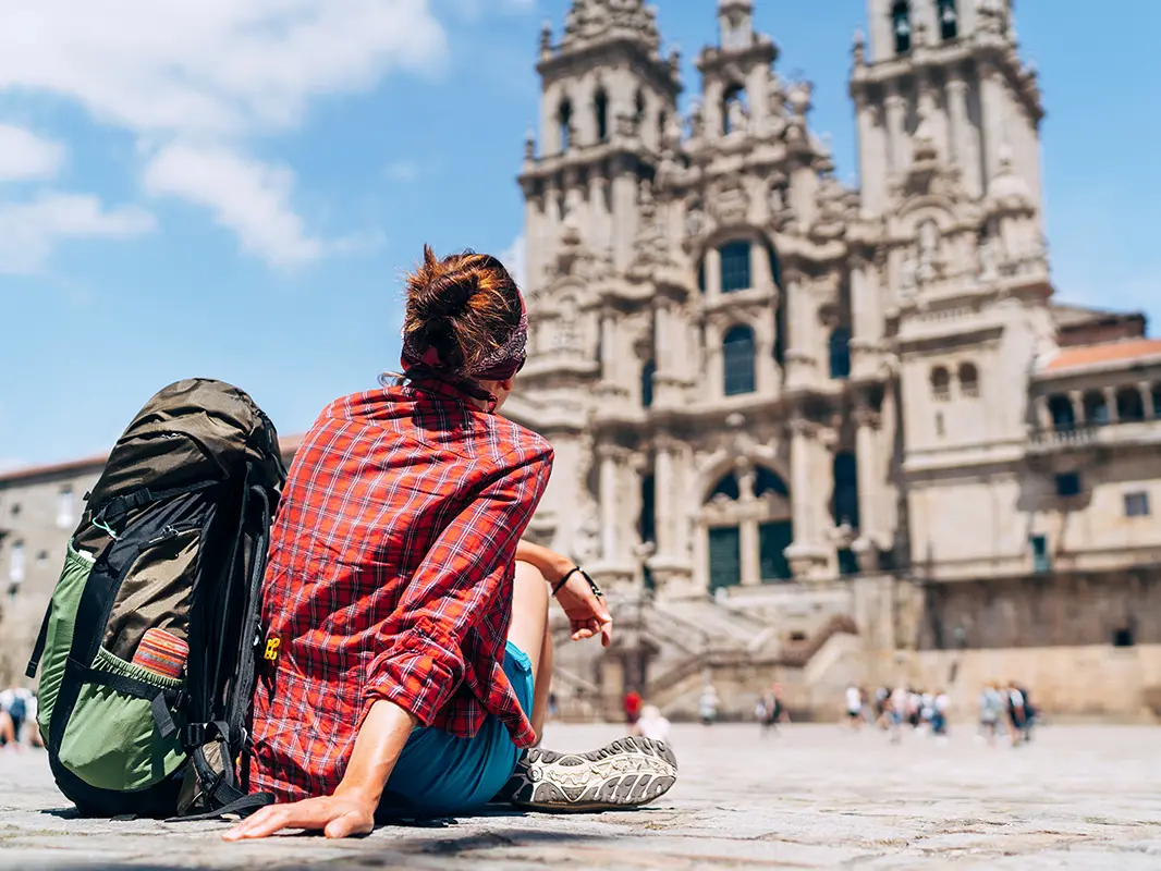 Woman sitting in front of old building