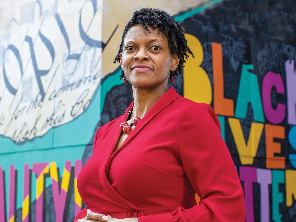 portrait of Andrea N. Williams standing in front of colorful murals