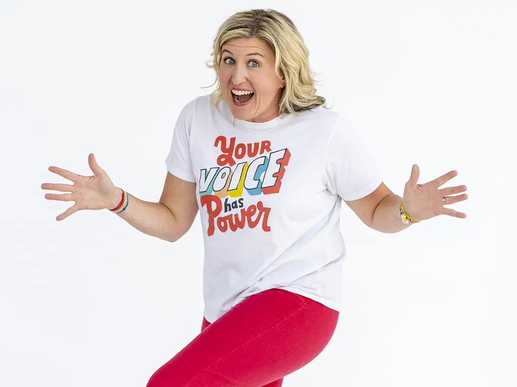 Katie Silcott dances in t-shirt that reads "Your voice has power."