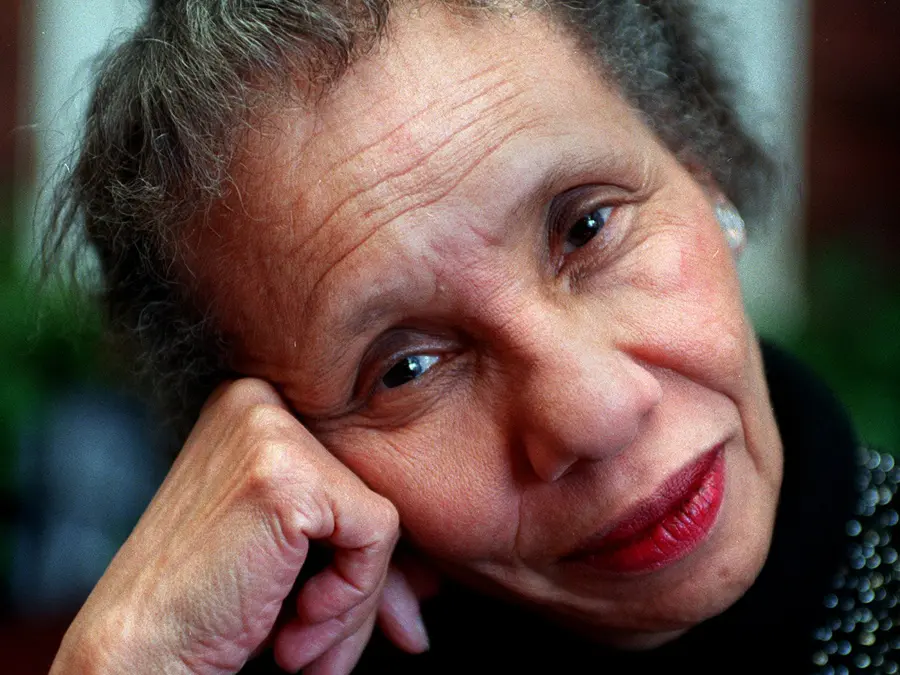 A portrait of Adrienne Kennedy gives a close-up view of an attractive black woman whose smiling eyes show her wisdom and her face, her years, as she leans her head on her hand. She’s wearing lipstick on her quietly smiling lips, a black turtleneck sweater with embellishments but no nail polish. Because of the way the photo is shot, her face is very in-focus but the background and her clothing become just hints of color and pattern.