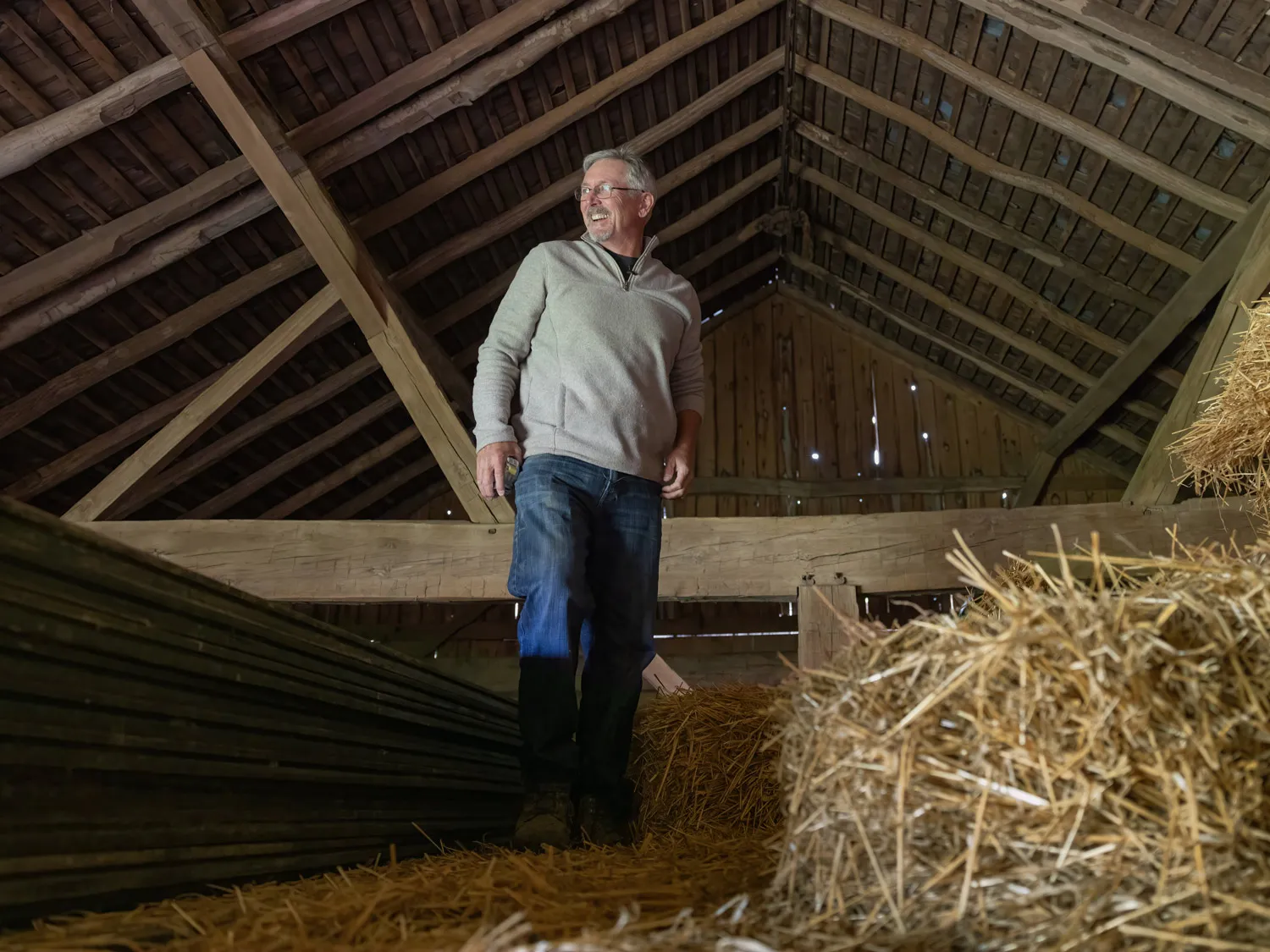 Doug Morgan surveys the loft inside an old barn he plans to dismantle, rebuild and refurbish, giving the old timber a new take on life.