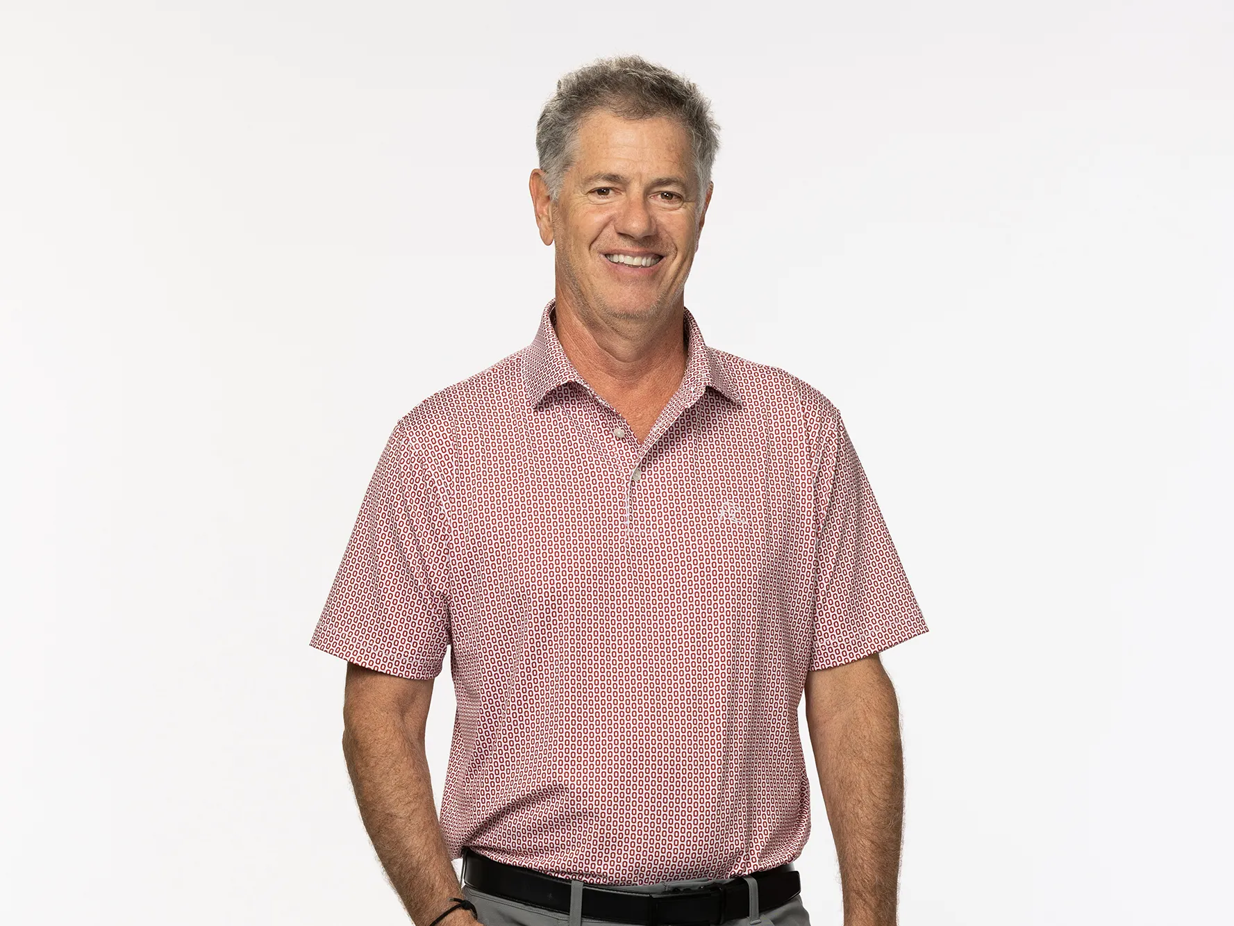 Joseph Ritchie, a middle-age white man with a nice smile, poses for a portrait with one hand tucked in the pocket of his pants and wearing stylish sneakers. He appears friendly and laidback. 