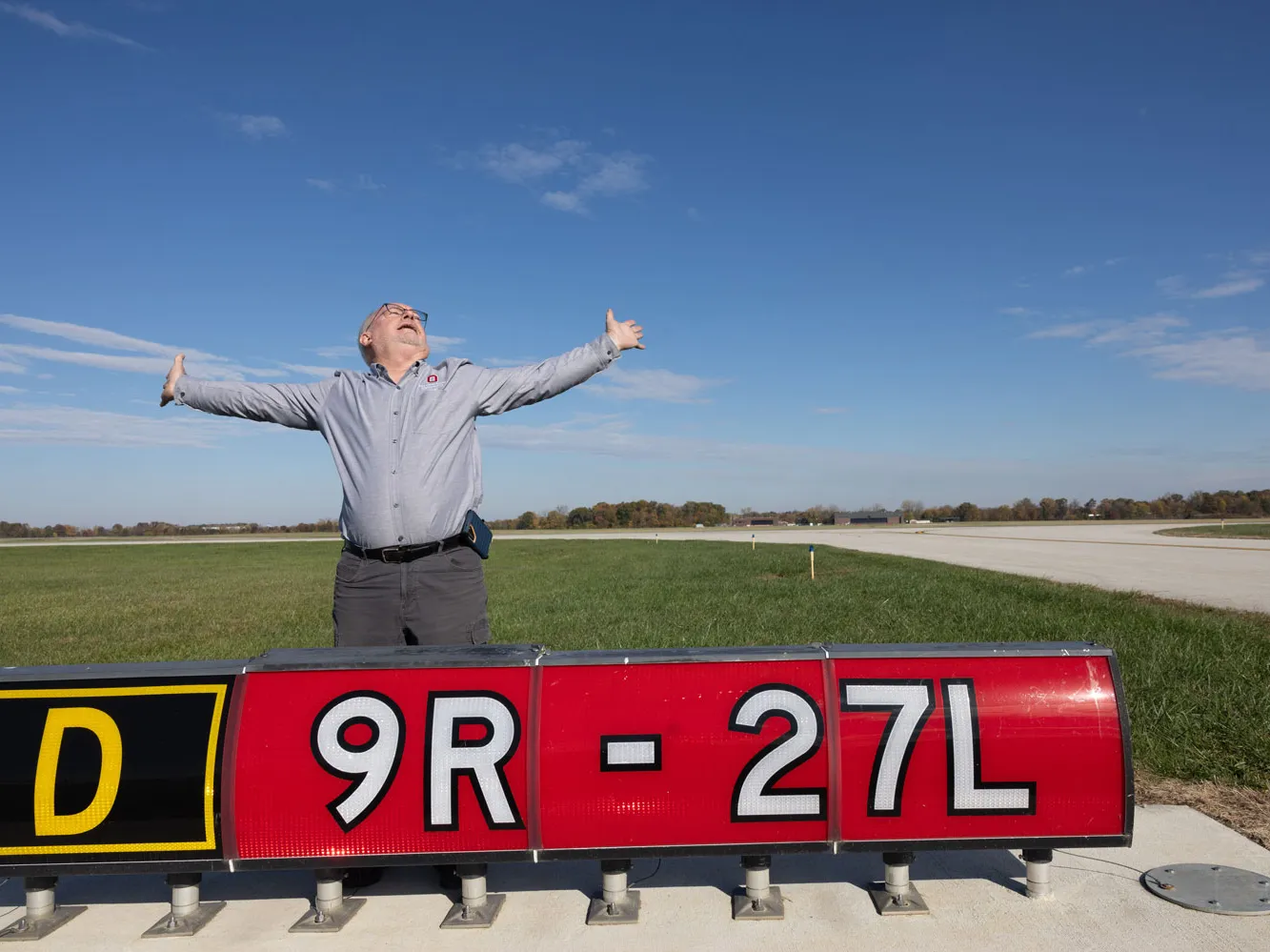 Light fixture check completed, Dale stretches his arms wide.