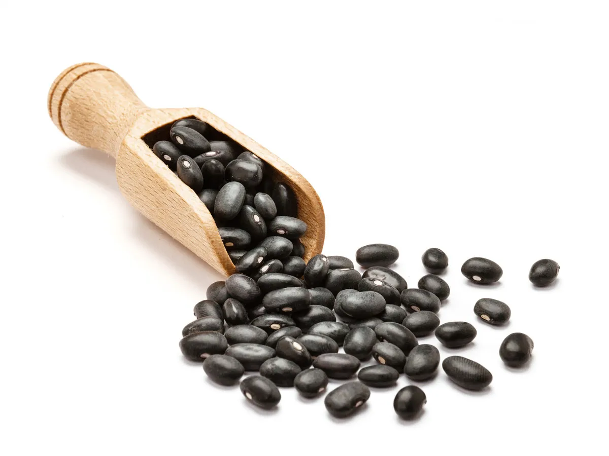 a scoop with black beans spilling out