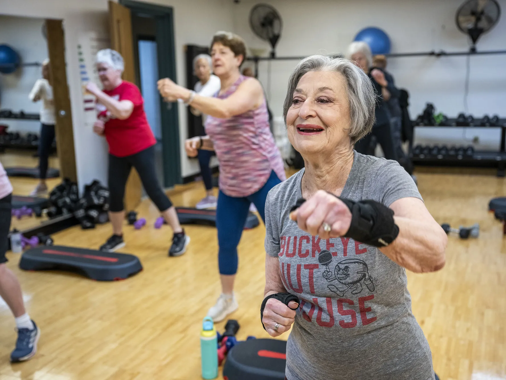 Flo Shleiferman Gurwin smiles as she works out in a cardio class