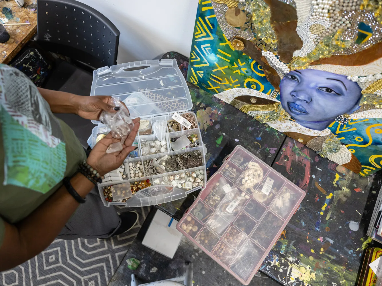 Sunami gathers beads from various boxes in her studio