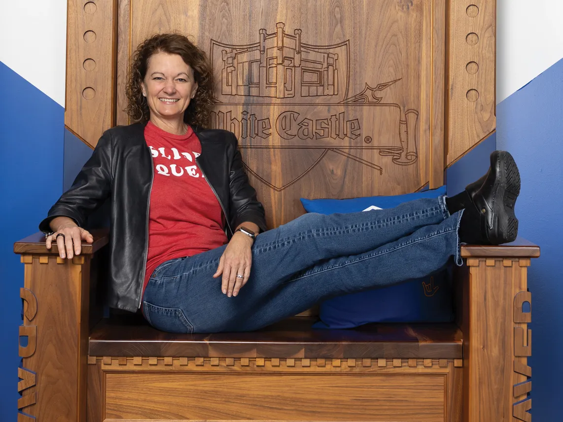 Lisa Ingram laughs as she lounges in the White Castle throne in the company's Craver museum, a favorite destination for customer enthusiasts.