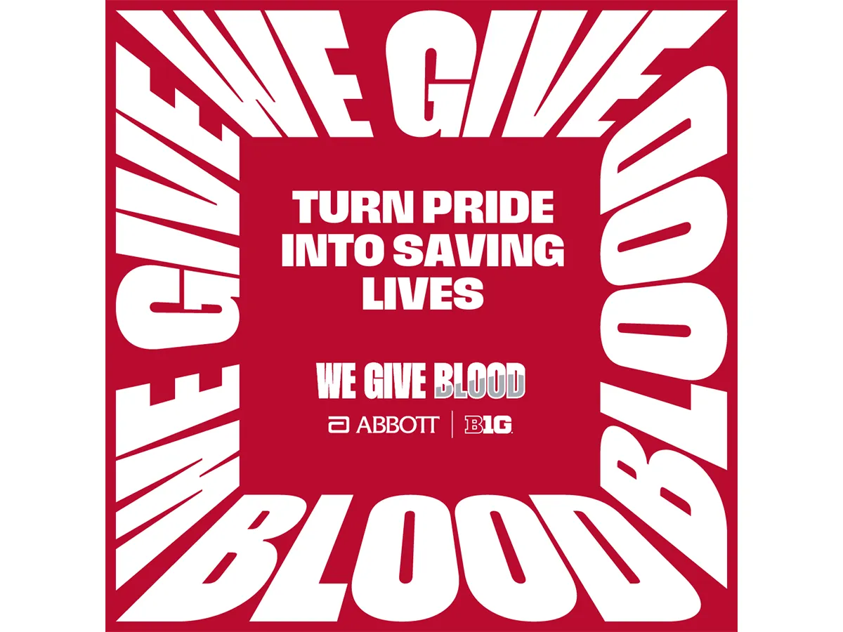 Red and white blood donation campaign poster with the words “WE GIVE BLOOD” stretched around the border in large distorted white letters. In the center, white text reads “TURN PRIDE INTO SAVING LIVES” above “WE GIVE BLOOD,” with Abbott and Big Ten logos below. The background is solid red.